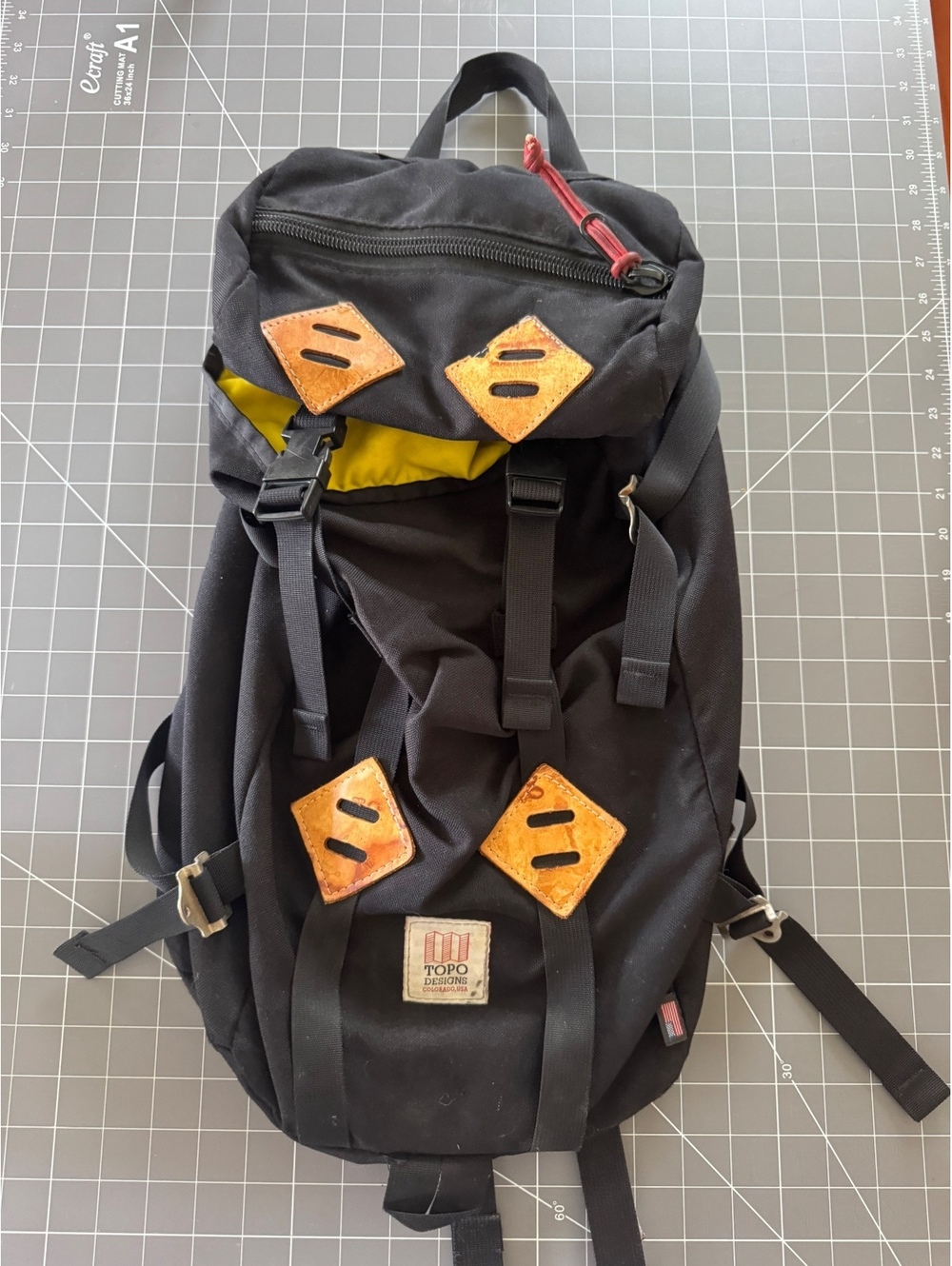 Topo Designs black backpack with tan leather patches